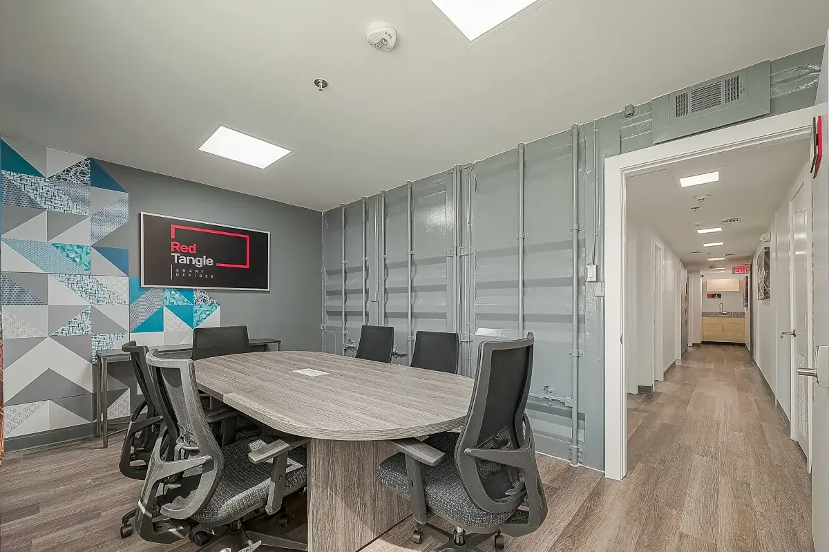 Private meeting room with conference table and audio-visual technology at Red Tangle Workspaces