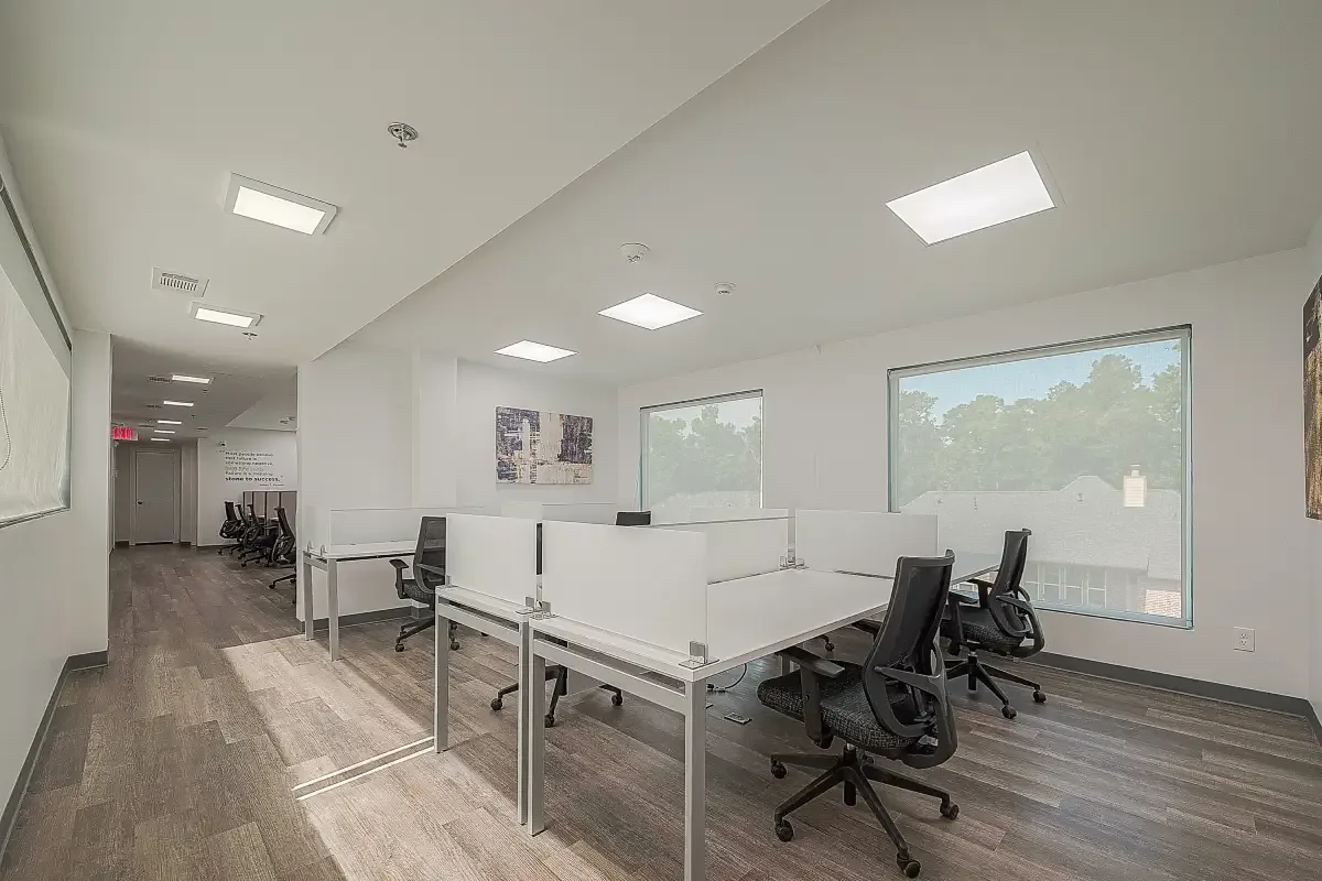 Open coworking area with shared workstations and natural light at Red Tangle Workspaces